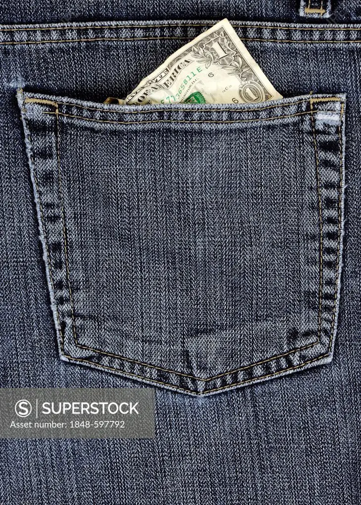 Crumpled 1 US dollar bill in a jeans pocket