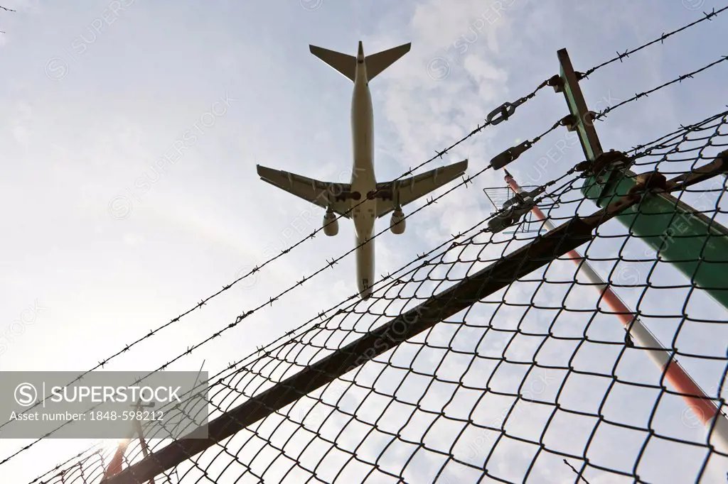 Plane approaching the airport flying over a fence, Frankfurt, Hesse, Germany, Europe
