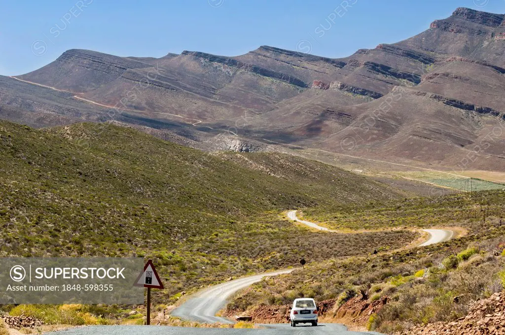 Car travelling on the road, warning sing for gravel road, Cederberg mountains, Western Cape, South Africa, Africa