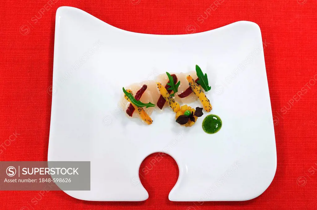 Scallops, mango and air-dried meat decorated with rocket leaves, served on a white plate, Haute Cuisine