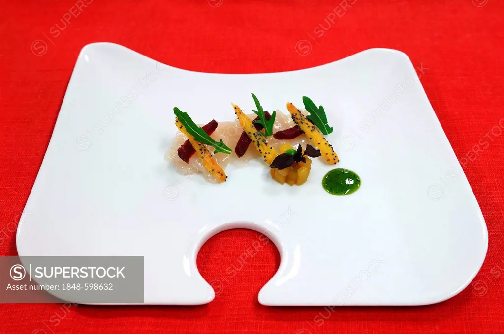 Scallops, mango and air-dried meat decorated with rocket leaves, served on a white plate, Haute Cuisine