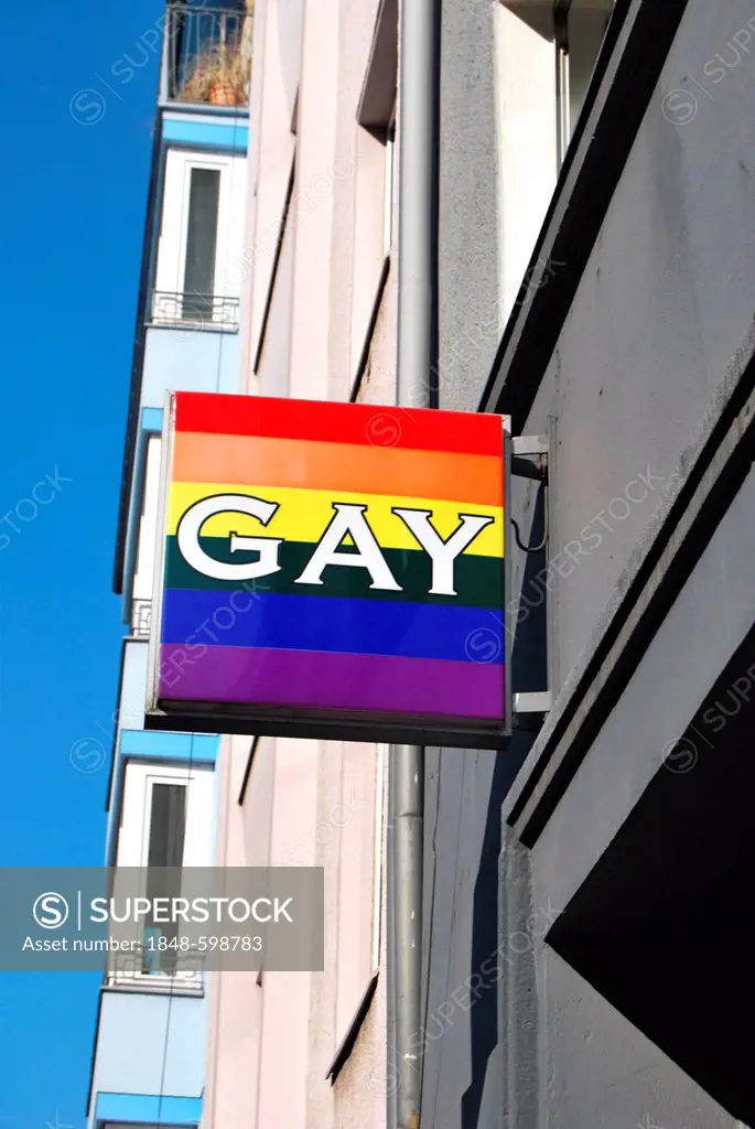 Gay, neon sign in rainbow colors on the façade of a sex shop