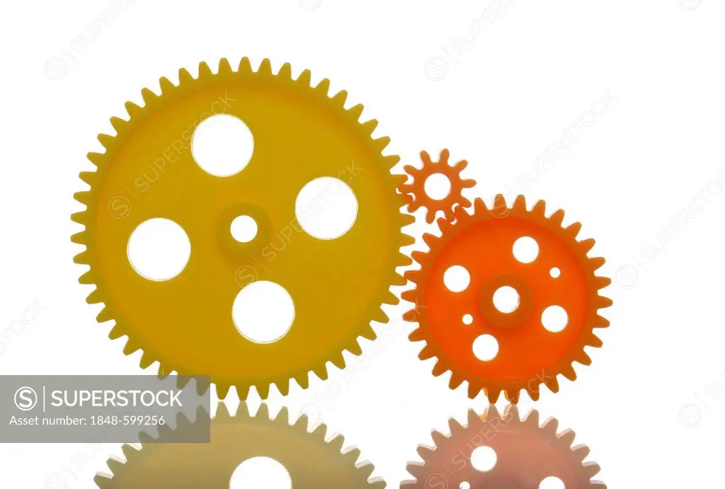 Yellow and orange cog wheels, symbolic image