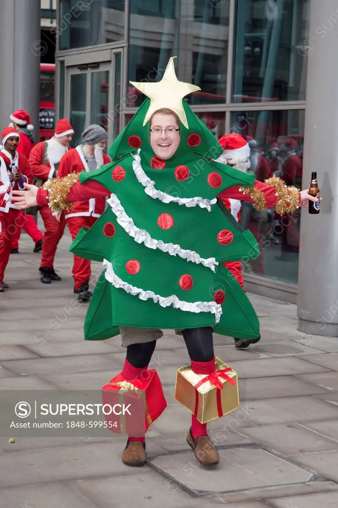 Man wearing a Christmas tree outfit, Santacon convention, London, England, United Kingdom, Europe