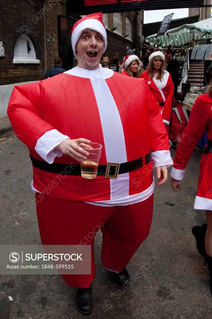 Man wearing an inflatable Santa suit, Santacon convention, London, England, United Kingdom, Europe