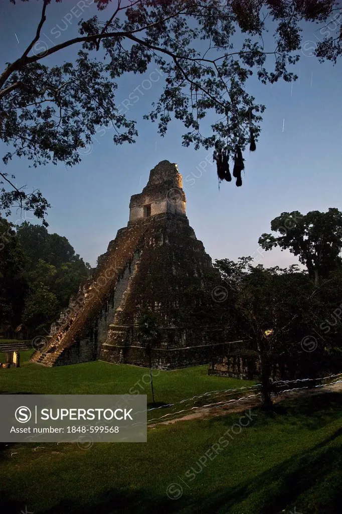 Group of students leave their lamp tracks while passing by Temple II at the Grand Plaza right before sunrise, Tikal archeological site, Peten Departme...
