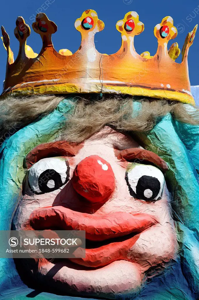 King wearing a crown with a comical facial expressions, smokes cigarillos, paper-mache figure, parade float at the Rosenmontagszug Carnival Parade 201...