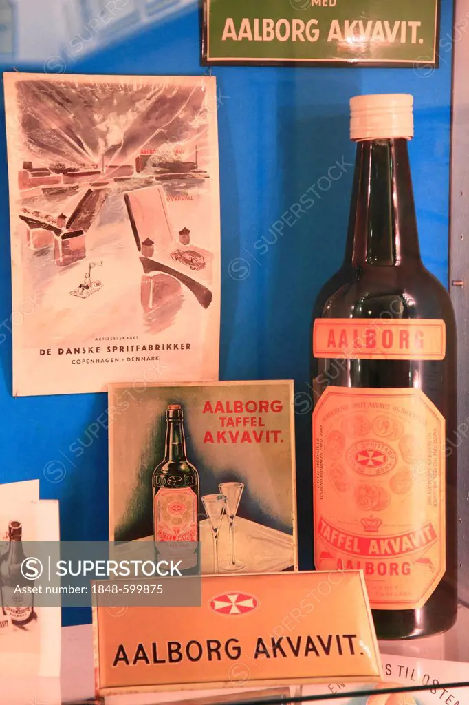 Advertising signs and old Akvavit bottle, Aalborg Akvavit spirits factory, Aalborg, North Jutland, Denmark, Europe