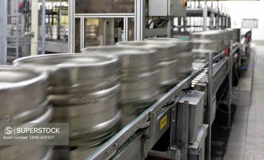 Beer kegs on a conveyor belt, waiting to be filled, with motion blur, Binding brewery, Frankfurt, Hesse, Germany, Europe
