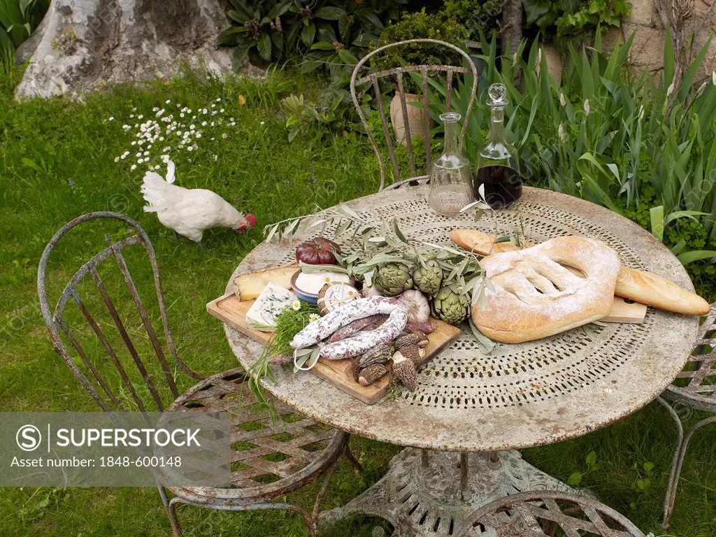 Mediterranean still life of a garden table covered with regional produce, Lourmarin, Provence-Alpes-Côte d'Azur, France, Europe