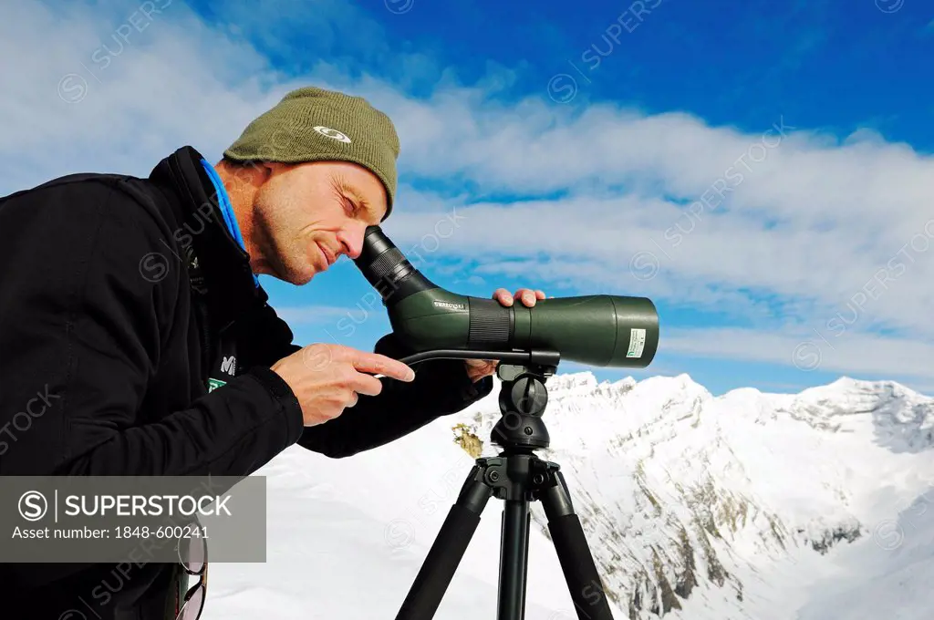 National Park Ranger looking through a spotting scope, Mount Schareck, National Park Hohe Tauern, Carinthia, Austria, Europe