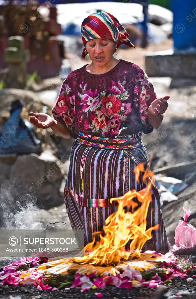 Quiche native woman honouring dead at the cemetery, Chichicastenango, Quiche Department, Guatemala, Central America
