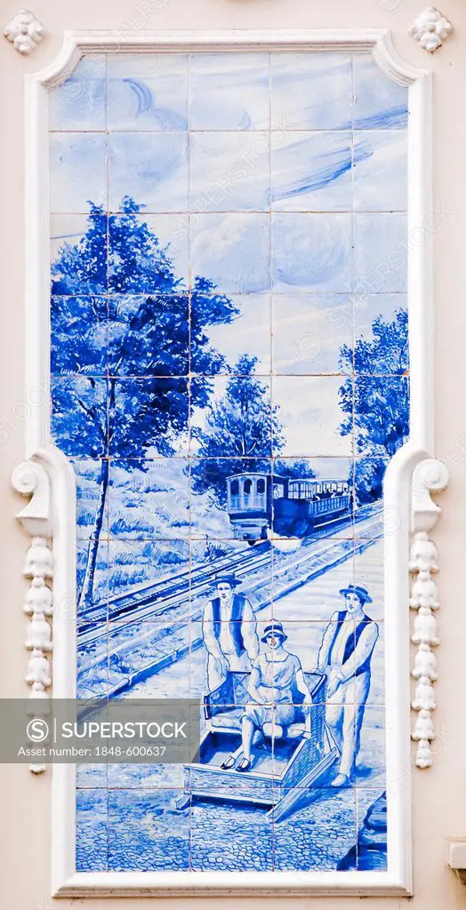 Azulejo, mural of ceramic tiles with a scene with a cog railway and basket sleigh ride in Funchal, on the municipal theater Funchal, Madeira, Portugal...