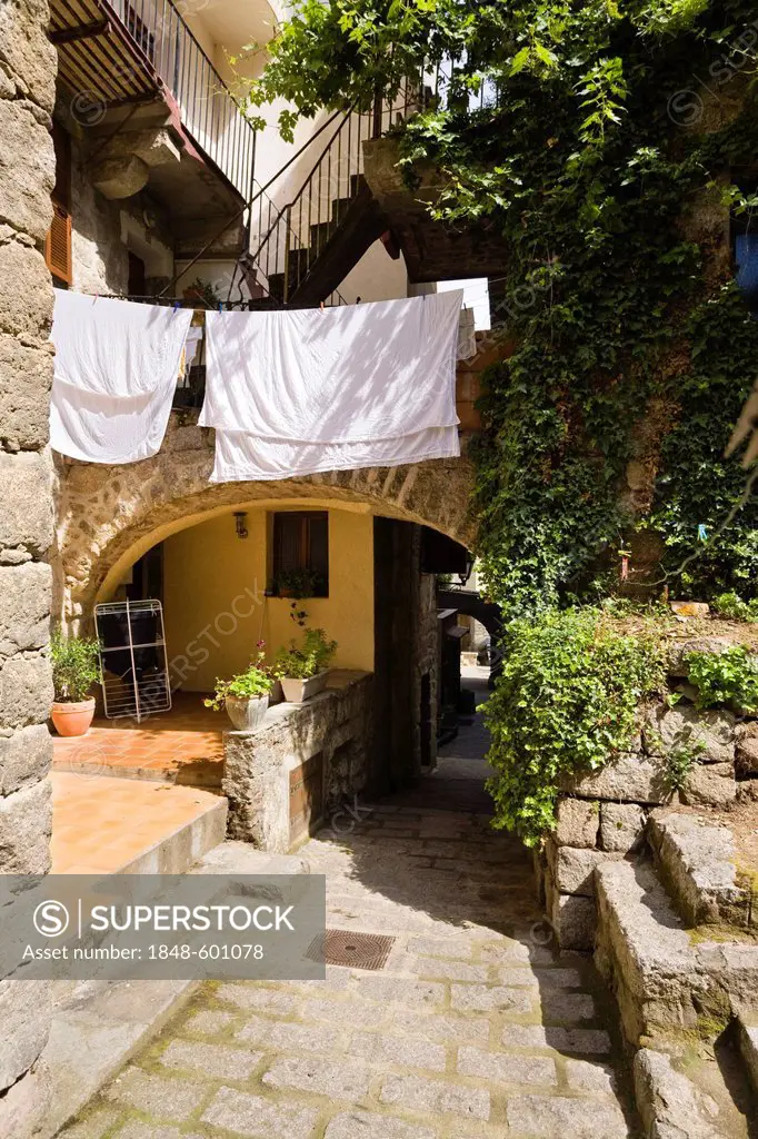 Alley with drying laundry, old town of Sartene, Corsica, France, Europe