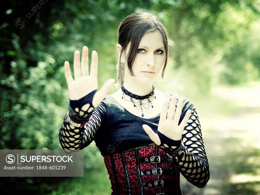 Woman, Gothic, dark-haired, raising her hand