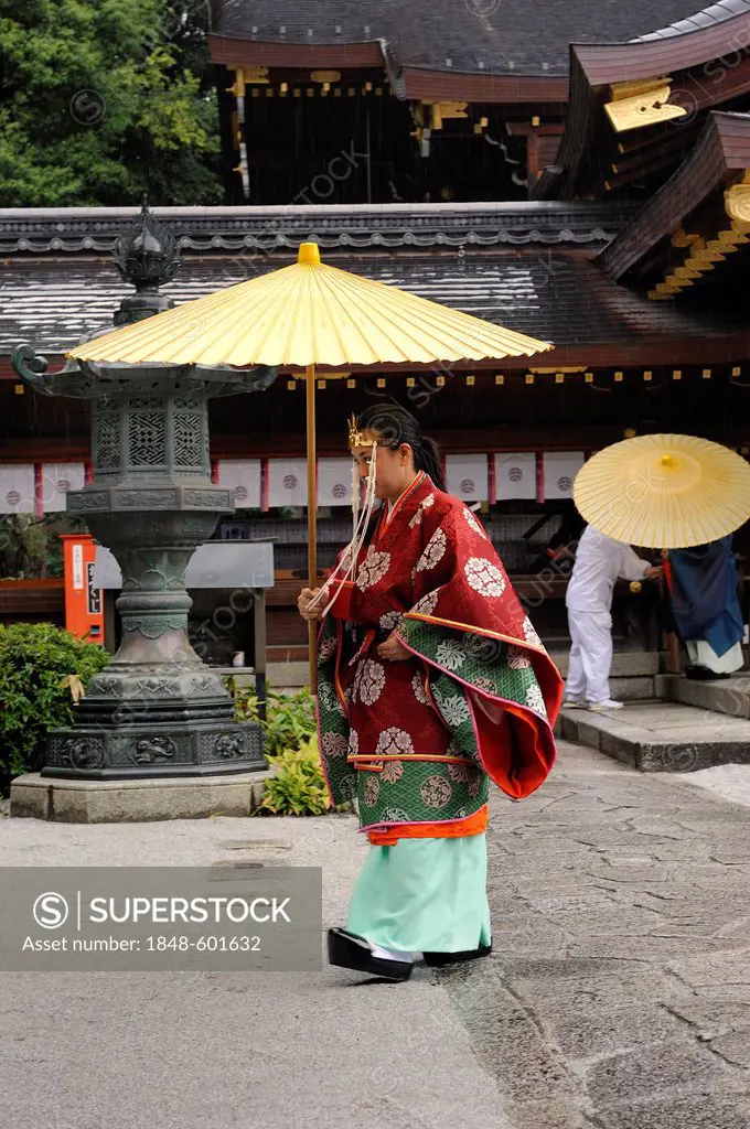 Miko, a female shaman, carrying an oil paper umbrella during a ceremony, Imamiya Shrine, Autumn Festival of Jidai-Matsuri, Kyoto, Japan, Asia
