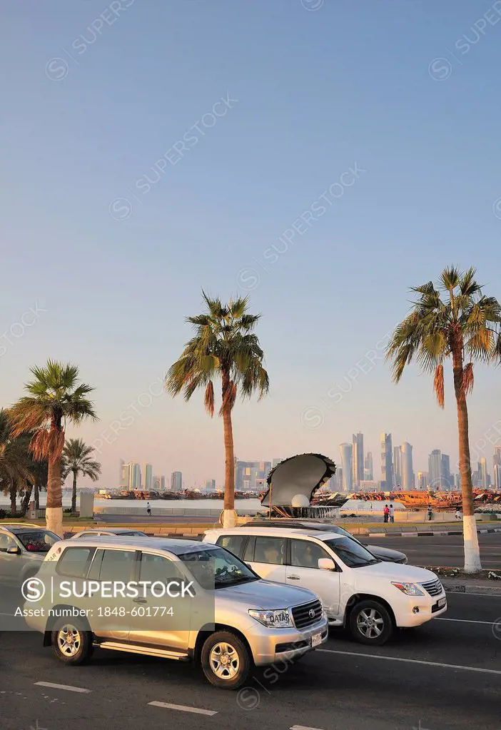 All-terrain vehicles on the Corniche in front of the Pearl and Oyster Fountain, Doha, Qatar, Middle East