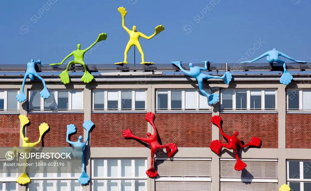 Flossis sculptures by artist Rosalie on the facade of the Roggendorfhaus building, Medienhafen port in Duesseldorf, North Rhine-Westphalia, Germany, E...