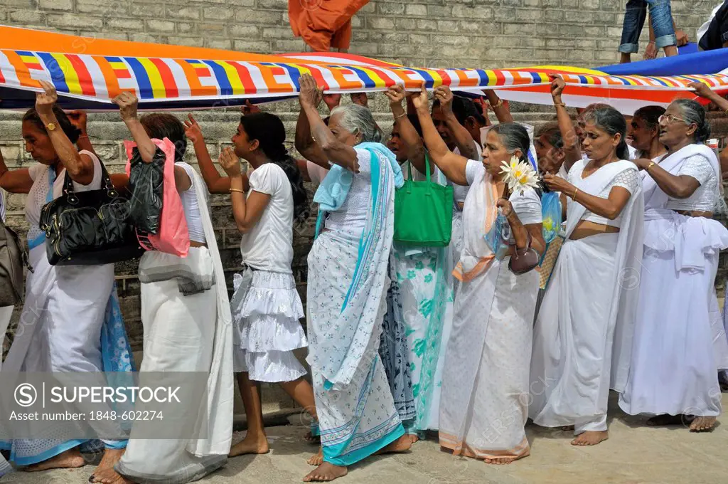 Puja, a 300m long Buddhist flag is being placed around the Ruvanveli Seya Dagoba, Anuradhapura, Unesco World Heritage site, Sri Lanka, Ceylon, South A...