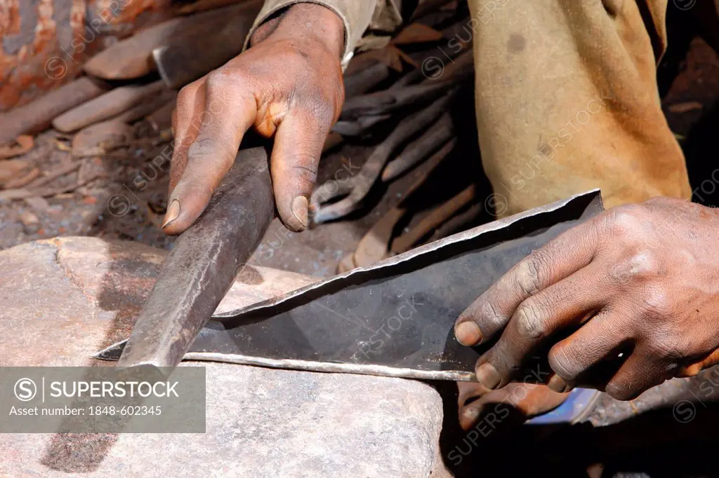Smith making a musical instrument from scrap metal, Babungo, Cameroon, Africa
