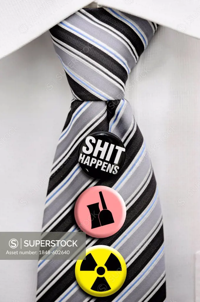 Tie with badges, symbols of radioactivity, a nuclear power plant and the message Shit happens