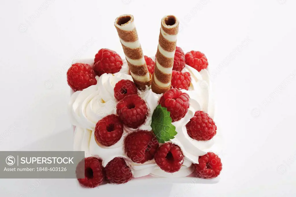 Raspberries with cream and striped biscuit rolls