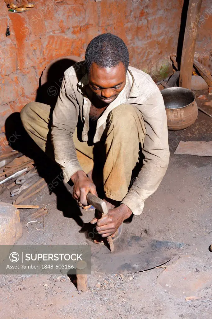 Smith making a musical instrument from scrap metal, Babungo, Cameroon, Africa