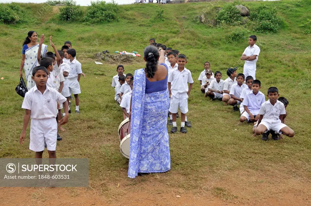 Boys wearing white uniforms during sports lessons, Galle, Sri Lanka, Asia