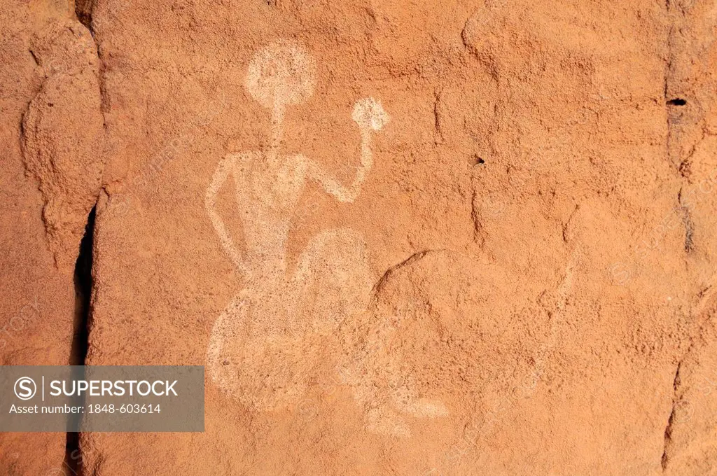 Painted sitting person, neolithic rock art of the Tadrart, Tassili n'Ajjer National Park, Unesco World Heritage Site, Algeria, Sahara, North Africa