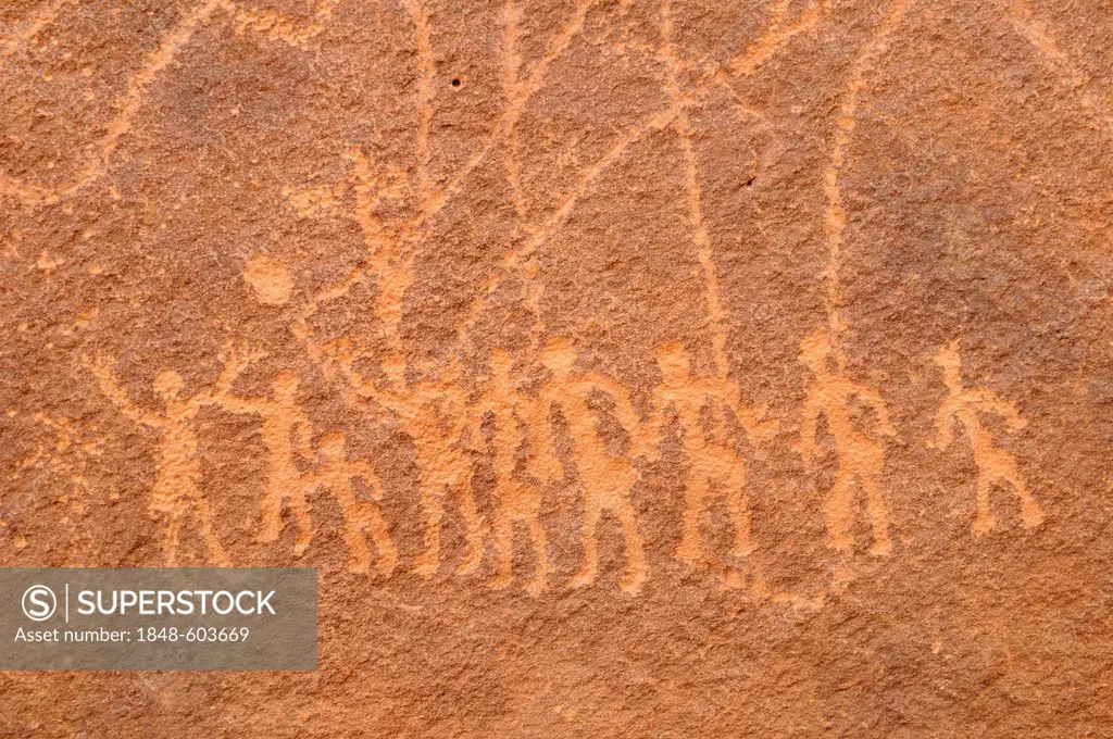 Engraving of a group of people, neolithic rockart of the Acacus Mountains or Tadrart Acacus range, Tassili n'Ajjer National Park, Unesco World Heritag...