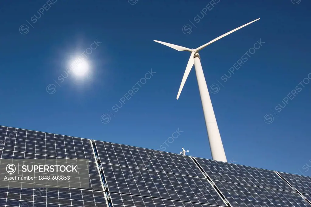 Solar panels, wind turbine, sun