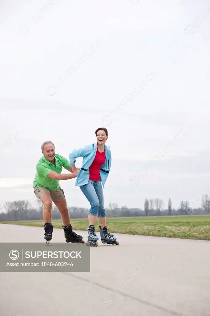 Man and woman inline skating together