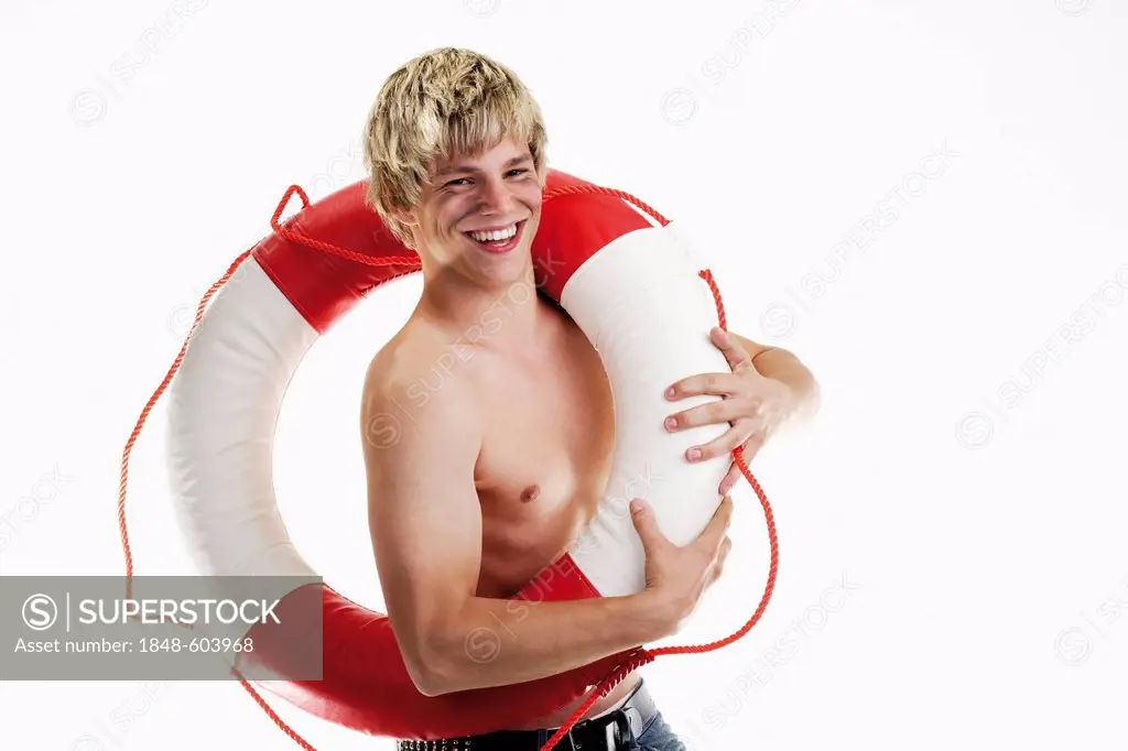 Young smiling man holding a life-saver in front of his naked torso