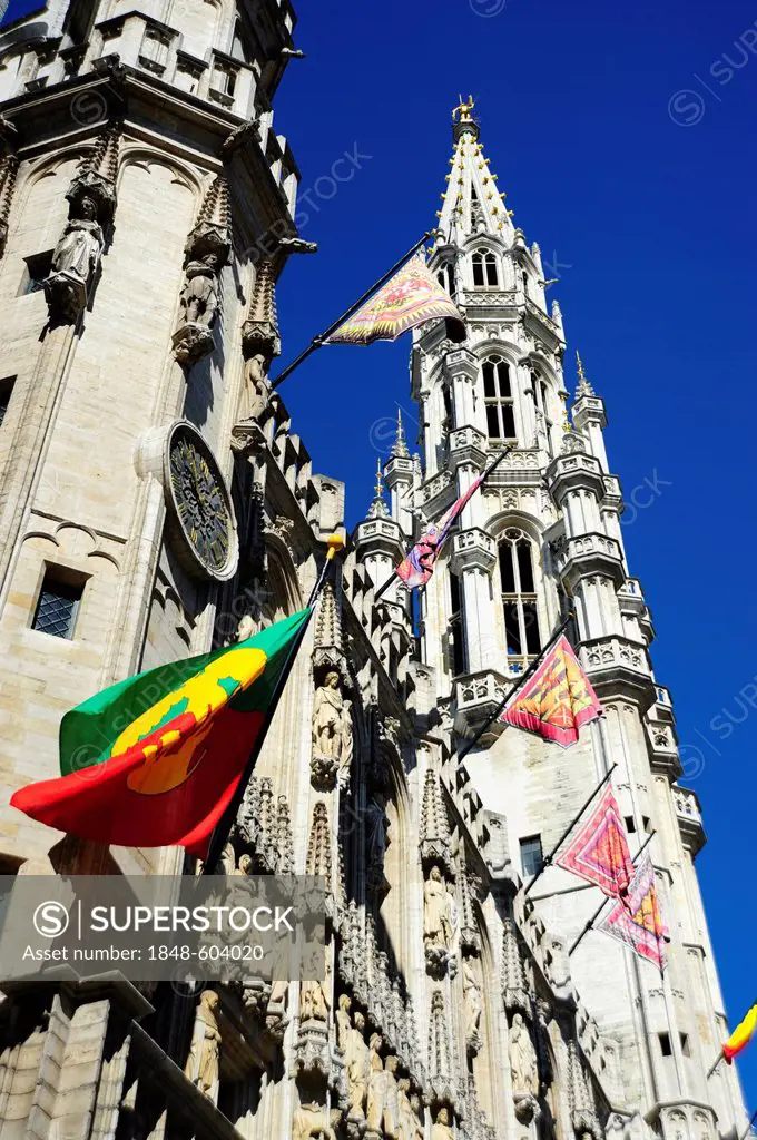 Town Hall with traditional flags and a Gothic style tower, Hotel de Ville on Grand Place or Stadhuis on Grote Markt square, city centre, Brussels, Bel...