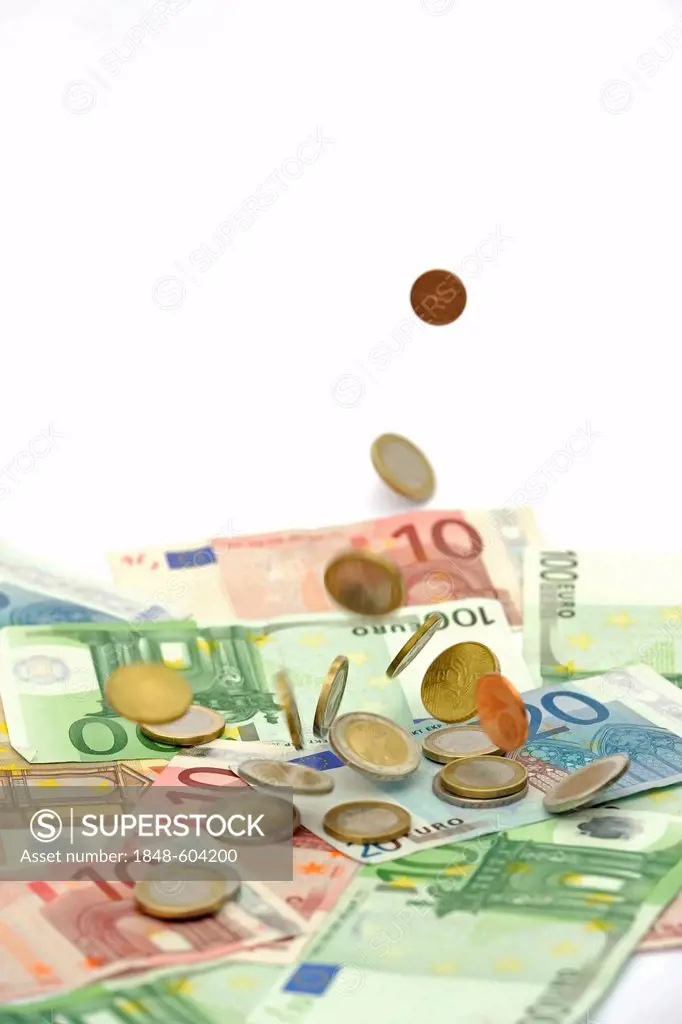 Euro coins falling on euro banknotes, raining money