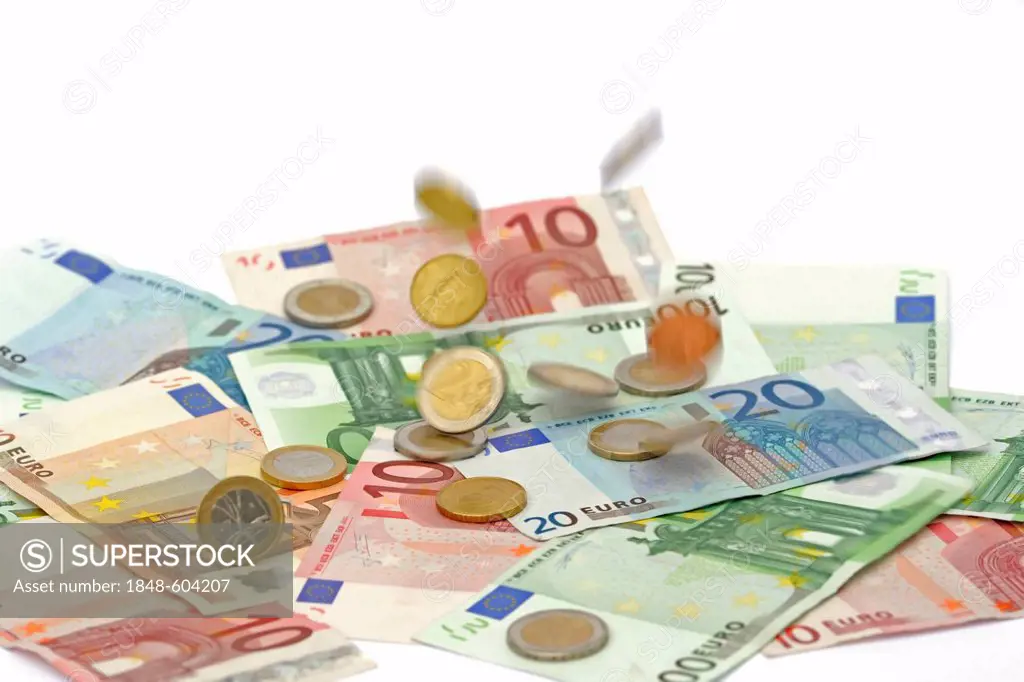 Euro coins falling on euro banknotes, raining money