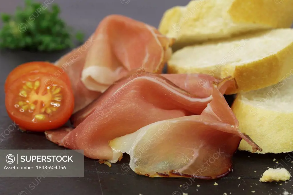 Black Forest ham with slices of baguette
