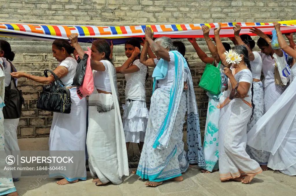 Puja, long cloth, 300 metres, Buddhist flag is draped around the Ruvanveli Seya Dagoba or Ruwanweliseya Dagoba, Anuradhapura, Unesco World Heritage Si...