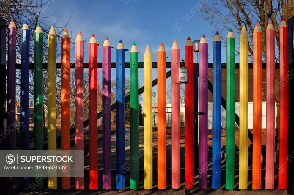 Large coloured pencils forming the gate of the A. Mozart School, Rue de l'Hôtel de Ville, Marckolsheim, Alsace, France, Europe