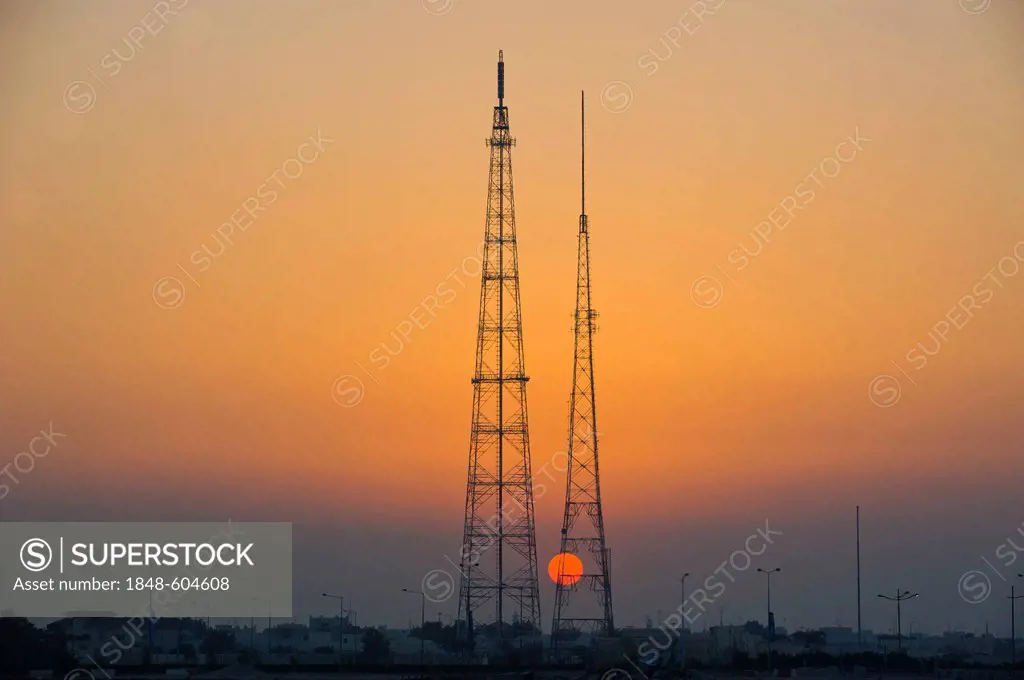 Giant electricity pylon in front of a setting sun, Doha, Qatar, Arabian Peninsula, Middle East