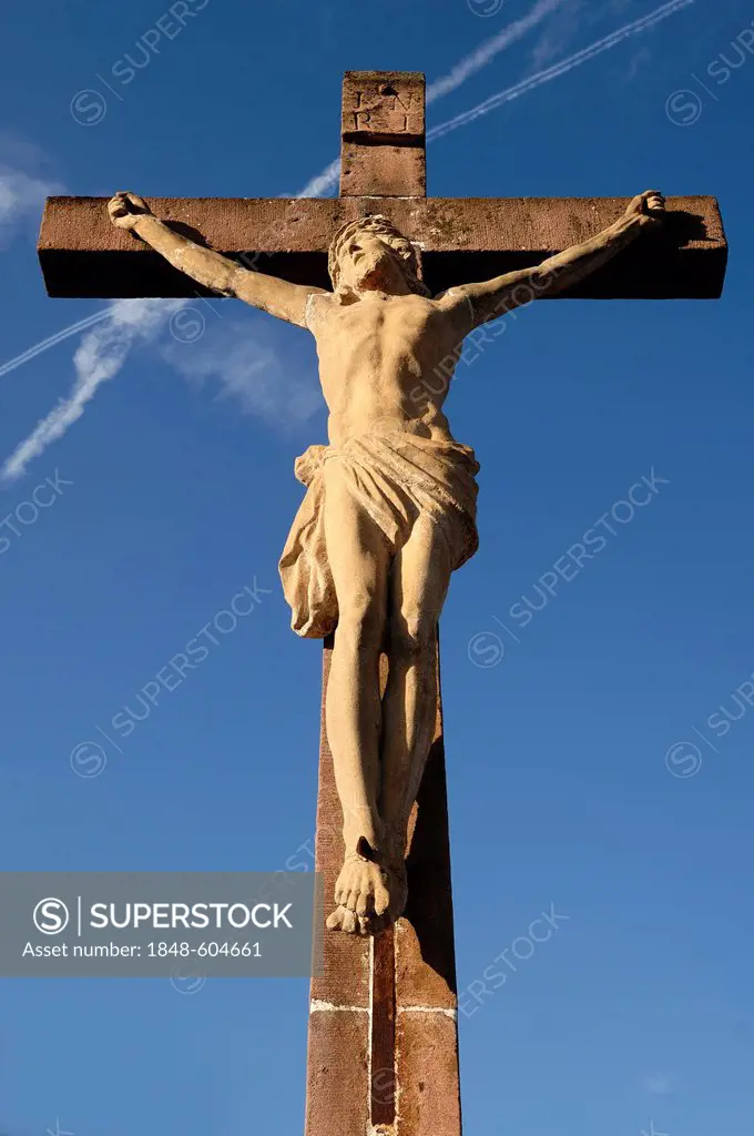 Stone crucifix, 19th Century, against a blue sky in the cemetery of Guebwiller, Route de Colmar, Guebwiller, Alsace, France, Europe