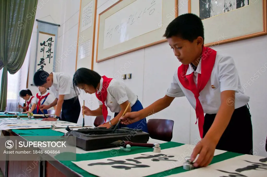 Selected children practicing calligraphy in the Children's Palace, Pyongyang, North Korea, Asia