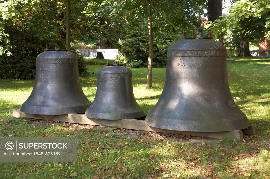 Three old bells in front of the Peter-Pauls-Kirche church, Coswig, Saxony, Germany, Europe
