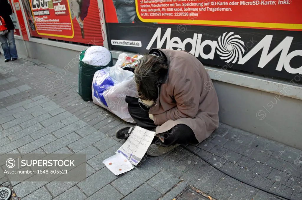 Homeless person in front of the Media Markt store in Hohe Strasse, Cologne, North Rhine-Westphalia, Germany, Europe