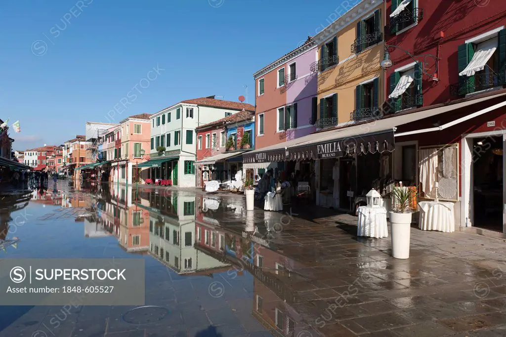 Winter floods, aqua alta, flooding the main shopping street, houses are reflected in the water, Burano Island, Venice, Italy, Southern Europe