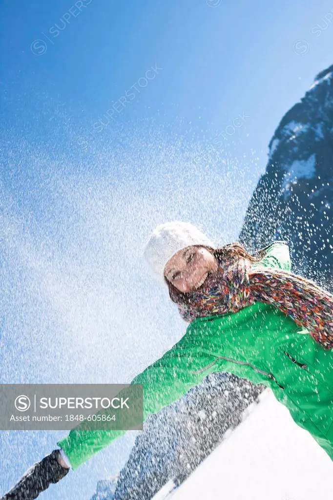 Woman throwing snow into the air