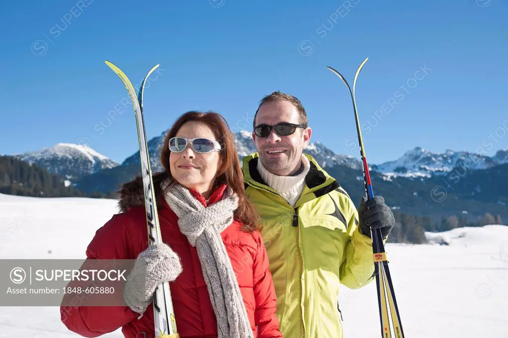 Couple with cross-country skis in the mountains