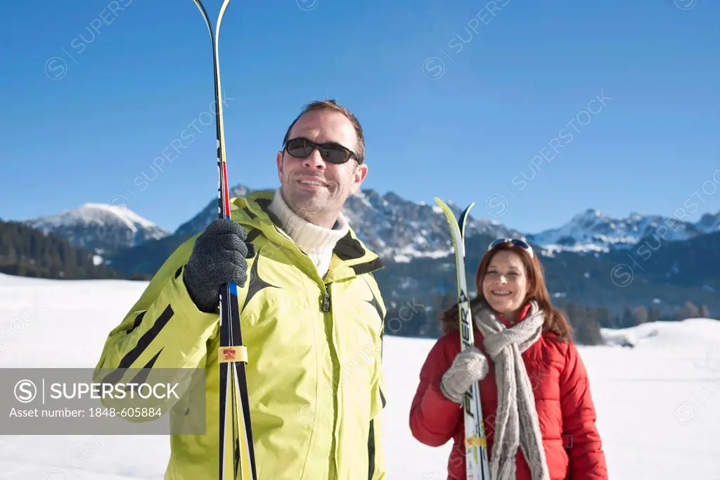 Couple with cross-country skis in the mountains