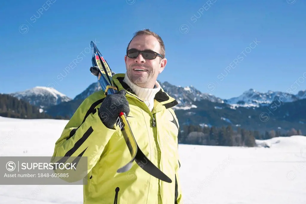 Man with cross-country skis in the mountains