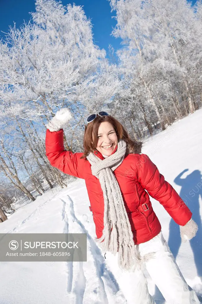 Woman throwing snow into the air